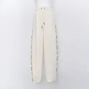 Puma 流行系列 Melody 女款 米白色 串標 運動 休閒 抽繩 縮口 口袋 亞規 長褲 63107487